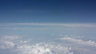 Sky clouds plane mountains ocean - an airplane window free wallpaper