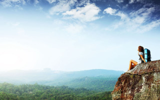 Person sitting mountains sky nature - a sky background and a person free wallpaper for desktop
