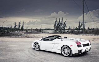 White sports car parking lot 19 - a cloudy sky in the background free wallpaper