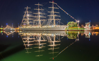 Large boat docked night sails - sail free wallpaper