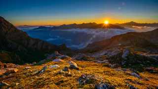 Sunset mountain range clouds horizon 2 - a sunset over a mountain range free wallpaper