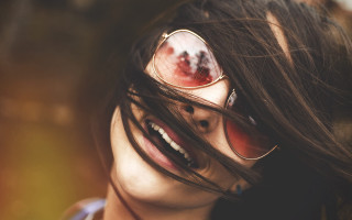 Woman sunglasses wind blown hair - her face and hair free wallpaper