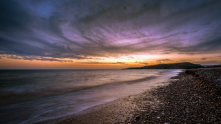 Beach sunset water hill clouds - a hill in the distance free wallpaper for desktop