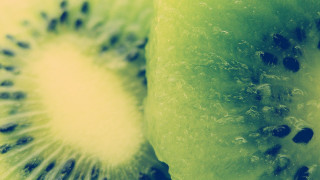 Kiwi fruit half green background - black dot free wallpaper