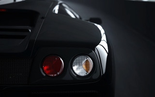 Black sports car lit up - its light free wallpaper