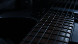 Guitar neck strings dark light - a close up of a guitar neck free wallpaper