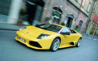 Yellow sports car city clock - a tall building free wallpaper