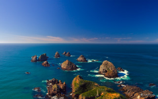 Ocean rocks blue sky waves - a blue sky above them free wallpaper