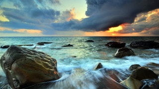 Sunset ocean rocks waves dusk - a sunset over the ocean free wallpaper