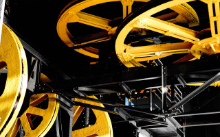 Clock yellow wheels mechanical puzzle - a close up of a clock free wallpaper