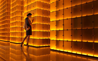 Woman orange lights cellphone backpack - front of a wall free wallpaper