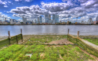 Cityscape bridge waterfront fence greenery - a grassy area in front free wallpaper