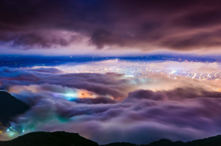 City lights clouds mist horizon - a view of a city free wallpaper