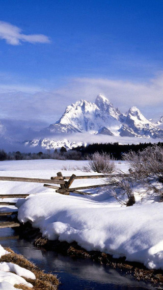 Snow covered mountain range creek - free winter wallpaper for mobile
