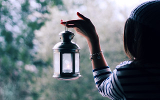Woman holding lantern outside window - a lantern free wallpaper