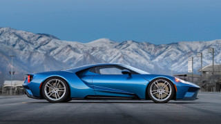 Blue sports car mountains sky - side profile free wallpaper