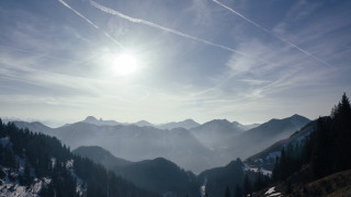 Mountain range sun trees lake - a view of a mountain range free wallpaper