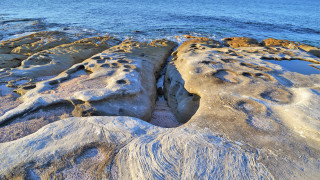 Rock formation water ice shore - a rock formation free wallpaper