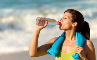 Woman drinking beach towel water - a bottle free wallpaper
