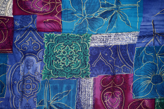 Colorful quilt flower blue background - a flower design free wallpaper