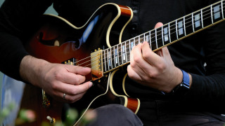 Man playing guitar black shirt - his lap free wallpaper