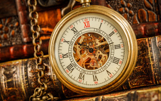 Gold pocket watch steampunk gears - top of a pile free wallpaper