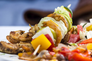 Shrimp lettuce tomatoes plate person 2 - a person in the background free wallpaper for desktop