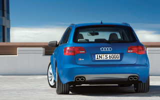 Blue car parked parking lot - a white fence free wallpaper