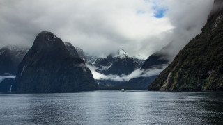 Boat mountains clouds water nature - the sky and a boat free wallpaper