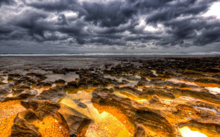 Rocky beach water rocks cloudy - a few cloud above free wallpaper