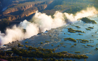 River steam bridge trees city - a bridge in the distance free wallpaper