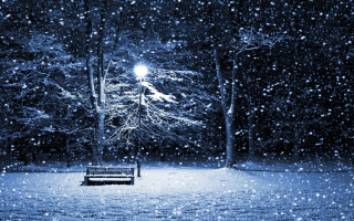 Snowy park night streetlight bench - a street light in the background free wallpaper
