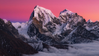 Mountain range sunset pink purple - cloud below free wallpaper