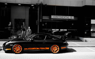 Black sports car orange rims - a white sign free wallpaper