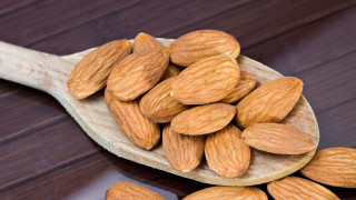 Wooden spoon almonds wooden table - a wooden spoon free wallpaper