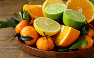 Bowl of oranges and limes - a table top free wallpaper