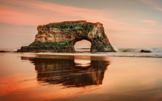 Beach rock reflection pink sky - a rock formation free wallpaper
