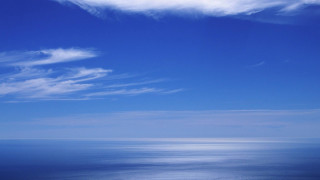 Lone boat ocean blue sky - free sky wallpaper for desktop