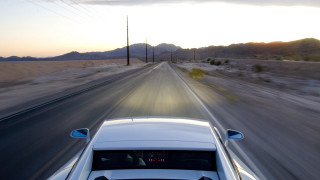 Desert road sunset car down - dynamic camera angle free wallpaper