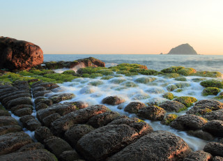 Rocky beach waterfall mountain horizon - a rock formation in the background free wallpaper