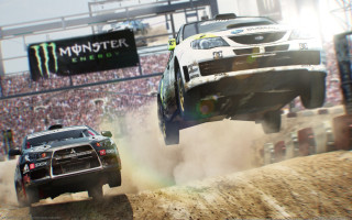Two cars jumping dirt hill - a monster truck free wallpaper