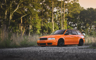 Orange car forest gravel road - an orange car free wallpaper