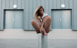Woman sitting pole blonde building - a pole free wallpaper