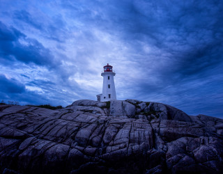 Lighthouse rocky outcrop dusk cloudy - white cloud free wallpaper