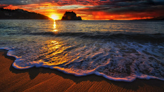Sunset ocean waves rocks cityscape - wave free wallpaper for desktop
