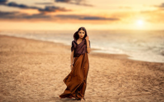 Woman beach dress sunset ocean - a sunset in the background and a body of water free wallpaper
