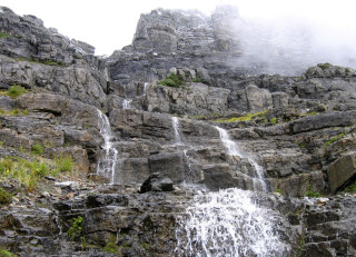 Waterfall rocks foggy sky person - a foggy sky above free wallpaper