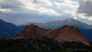 Mountain range clouds trees horizon - a few tree below free wallpaper