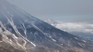 Mountain peak plane clouds ocean - tall peak free wallpaper