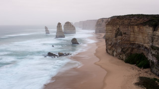 Beach cliff waves people ocean - a cliff and a body of water free wallpaper